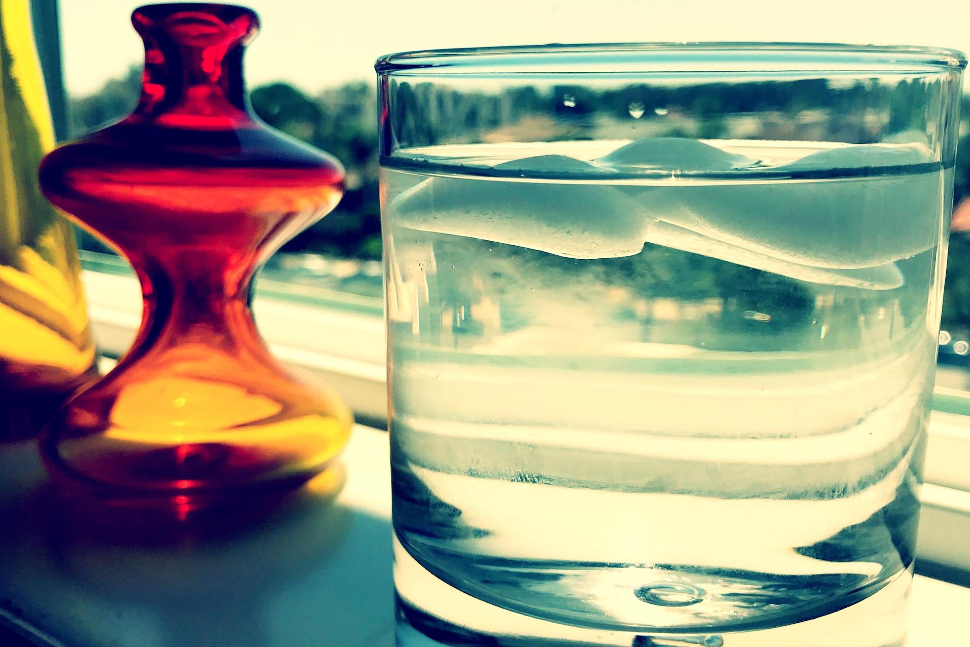 Ice cubes floating in glass of water